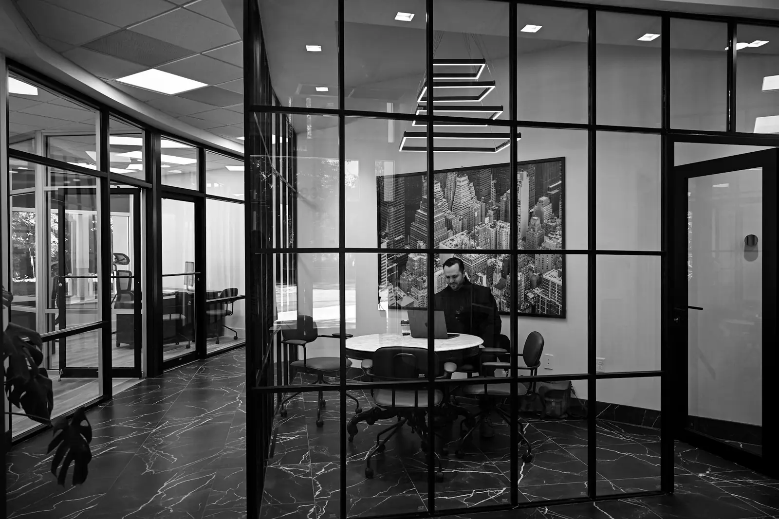 Person working in a glass-walled meeting room