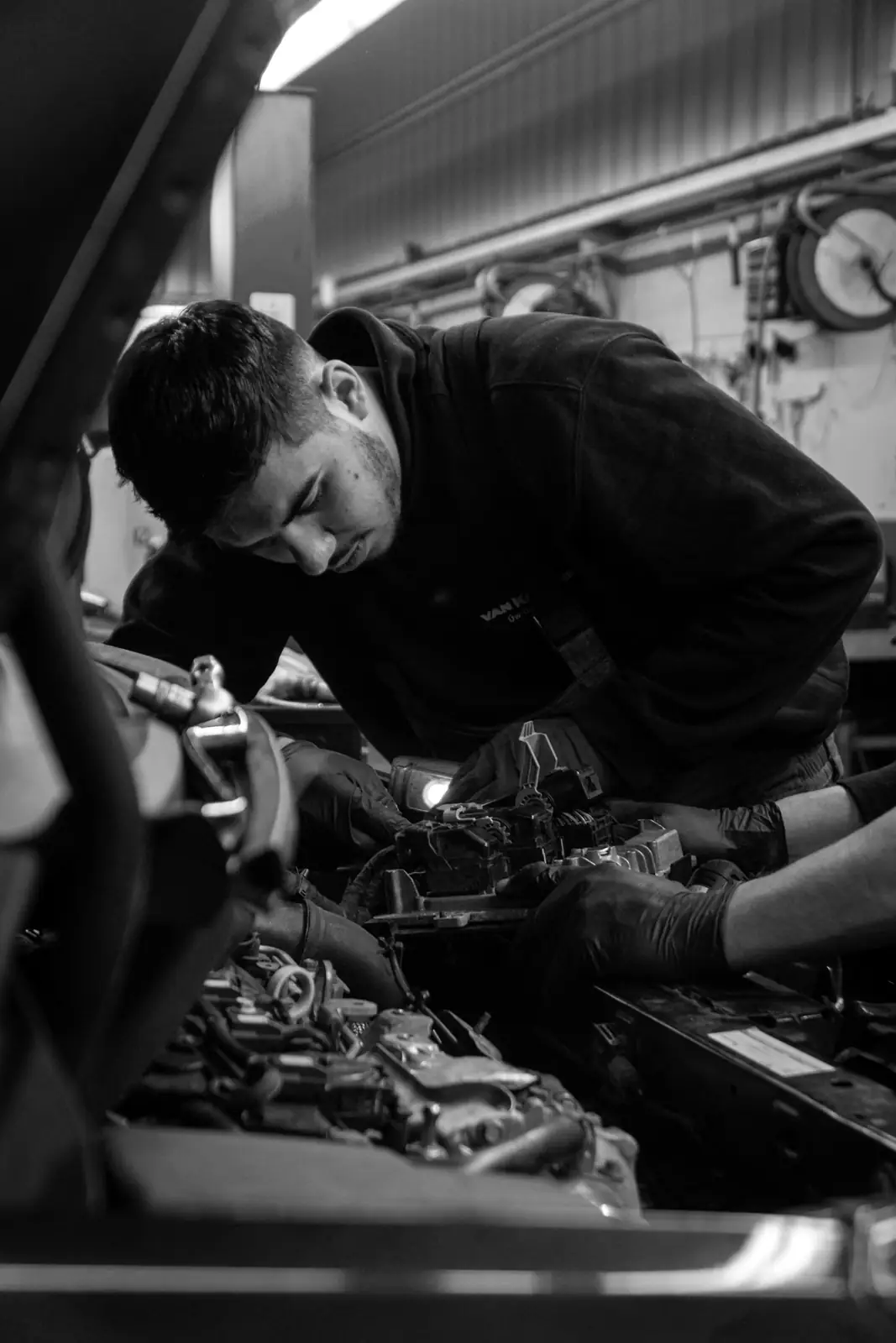 Mechanic working on an engine in a workshop